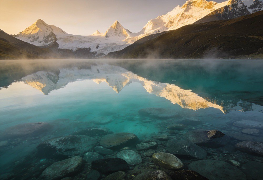 Pristine mountain lake with crystal clear water flowing over mineral-rich bedrock — naturally negative ORP