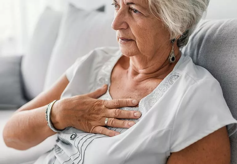 Individual experiencing heartburn, highlighting the impact of GERD on daily life.